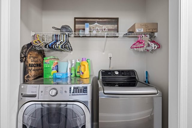 clothes washing area featuring washer and dryer