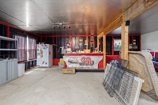 garage with white refrigerator with ice dispenser