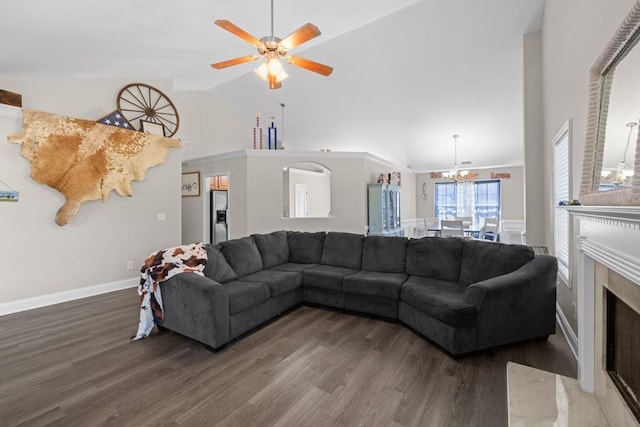 living room with a premium fireplace, dark hardwood / wood-style floors, and high vaulted ceiling