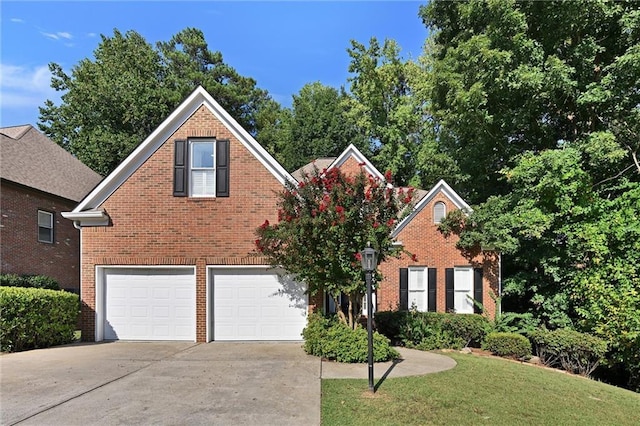 front facade featuring a garage and a front lawn