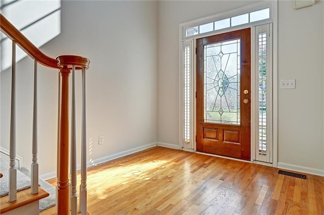 entrance foyer with a wealth of natural light and light hardwood / wood-style flooring