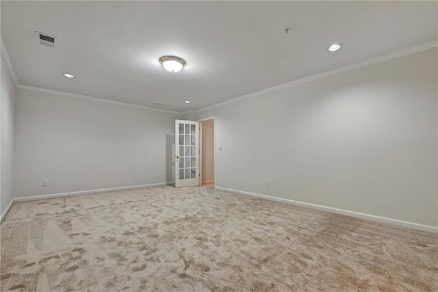 spare room featuring light carpet and ornamental molding