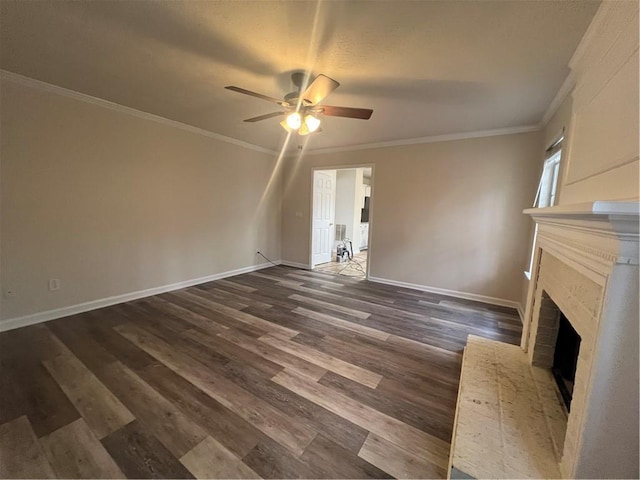 unfurnished living room with a brick fireplace, crown molding, dark hardwood / wood-style floors, and ceiling fan