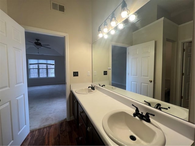 bathroom with vanity, hardwood / wood-style flooring, toilet, and ceiling fan