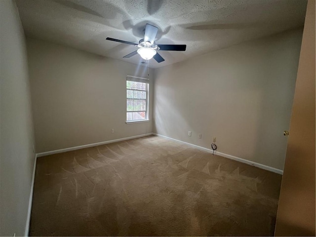 empty room featuring ceiling fan, carpet floors, and a textured ceiling