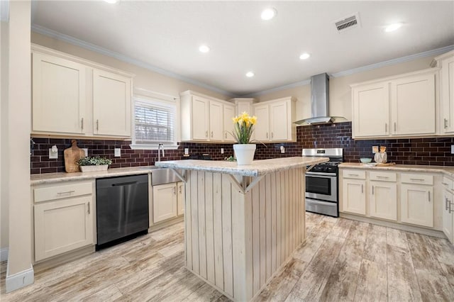 kitchen with dishwasher, crown molding, wall chimney range hood, and stainless steel gas range oven