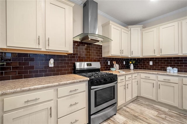 kitchen with decorative backsplash, wall chimney exhaust hood, stainless steel gas stove, and ornamental molding