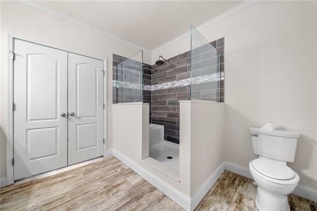 full bathroom featuring wood finished floors, ornamental molding, and a walk in shower