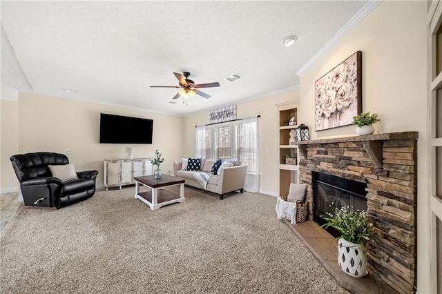 carpeted living area featuring baseboards, ornamental molding, a stone fireplace, a textured ceiling, and a ceiling fan