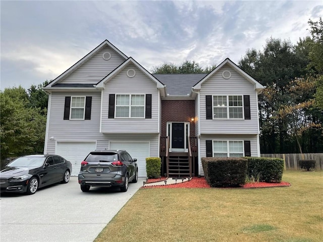 split foyer home with a garage and a front lawn