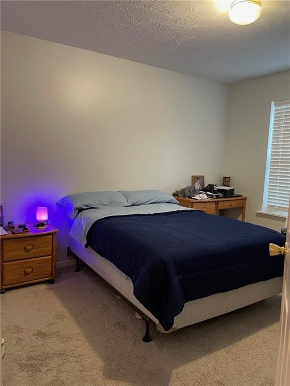 bedroom with a textured ceiling and carpet