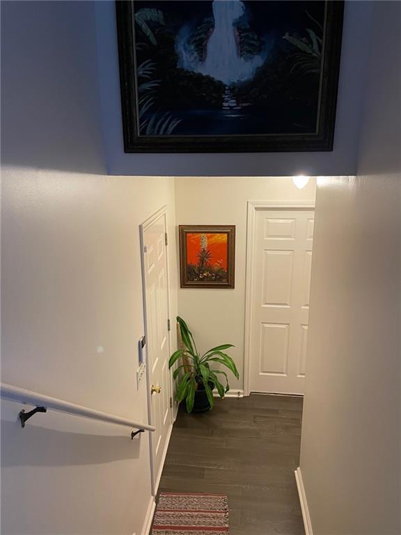 hallway featuring dark hardwood / wood-style flooring