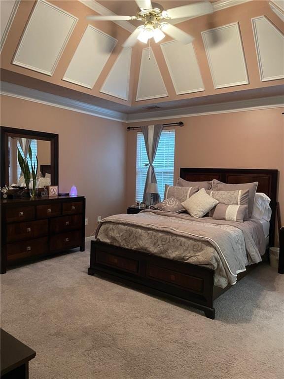 carpeted bedroom featuring ornamental molding and ceiling fan