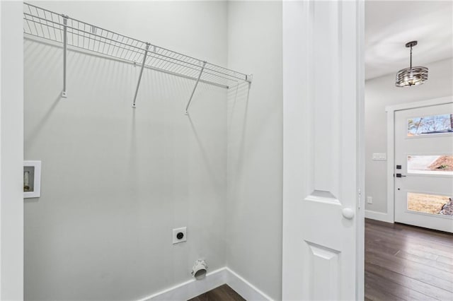 washroom featuring dark hardwood / wood-style flooring, washer hookup, and hookup for an electric dryer