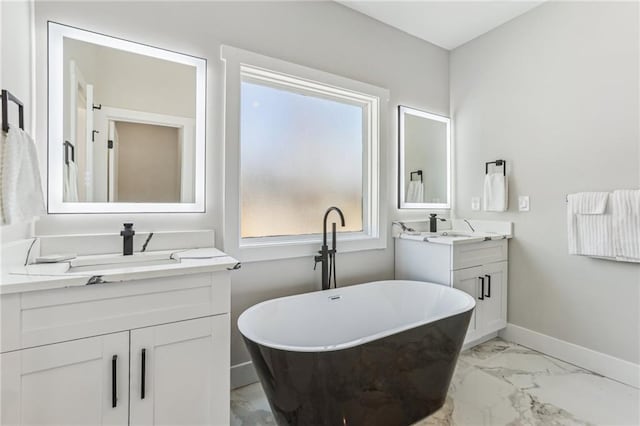 bathroom featuring a washtub and vanity