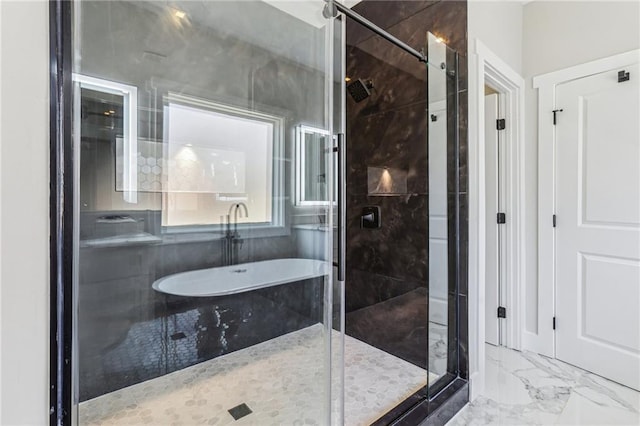 bathroom featuring shower with separate bathtub