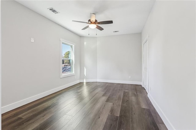 empty room featuring ceiling fan and dark hardwood / wood-style floors