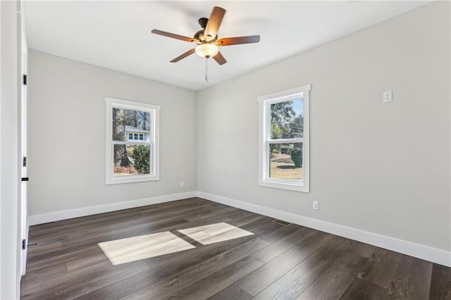 spare room with dark hardwood / wood-style floors and ceiling fan