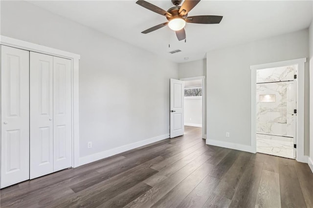 unfurnished bedroom with ensuite bathroom, a closet, ceiling fan, and dark hardwood / wood-style floors