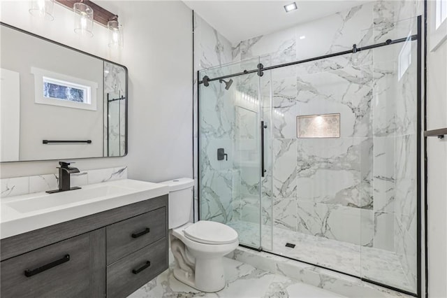 bathroom with vanity, toilet, and a shower with shower door