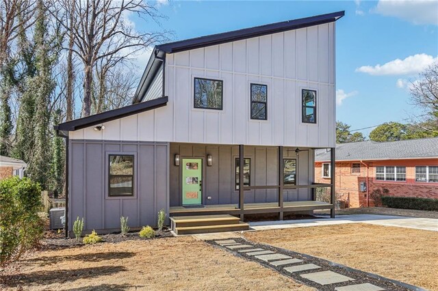 view of front of property with covered porch and central AC unit