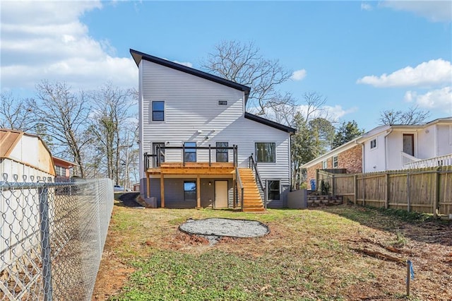 back of house with a deck and a yard