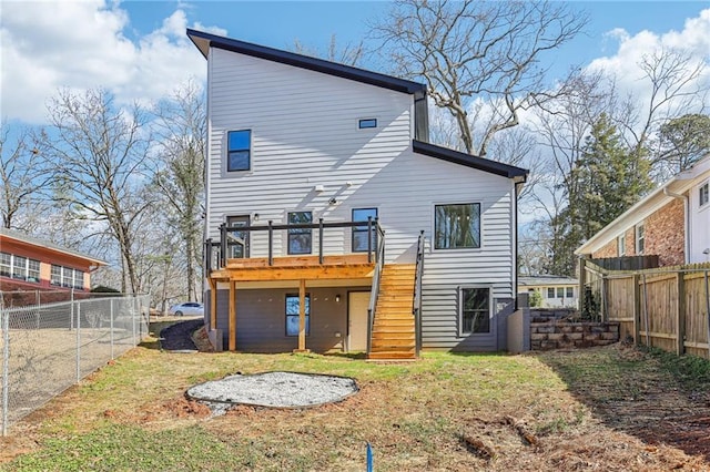 rear view of house with a lawn and a wooden deck