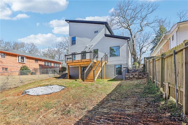 rear view of property with a deck and a lawn