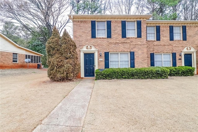 colonial home with brick siding