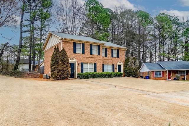 colonial-style house featuring brick siding