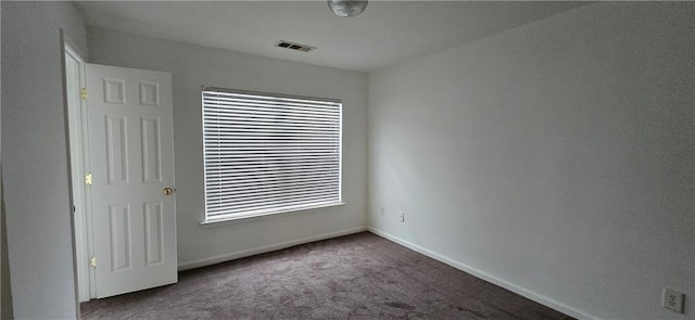 empty room with visible vents, baseboards, and carpet