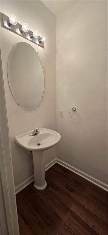 bathroom featuring baseboards and wood finished floors