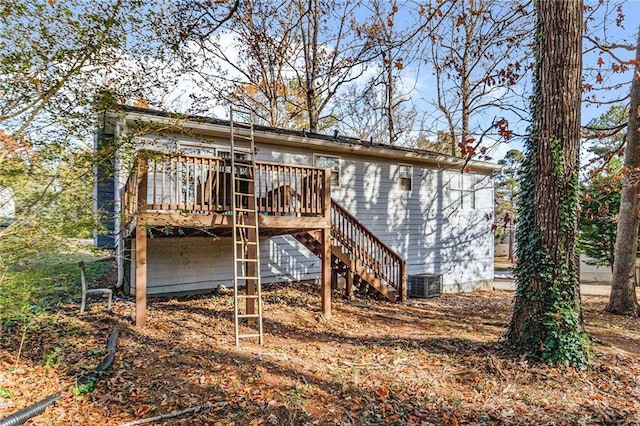 back of house with cooling unit and a deck