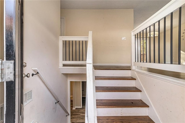 stairway featuring hardwood / wood-style floors