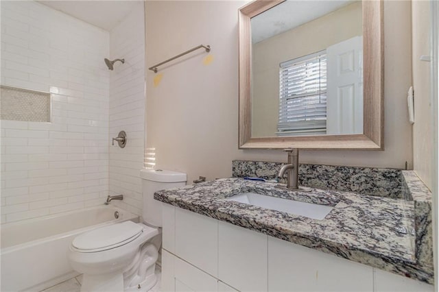 full bathroom featuring vanity, toilet, and tiled shower / bath