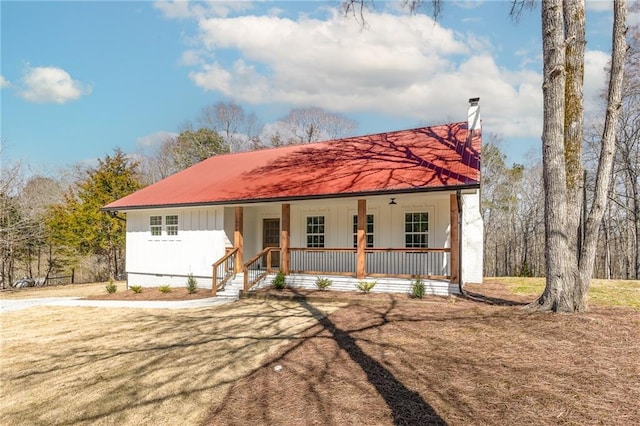 view of front of house with metal roof, a porch, and board and batten siding