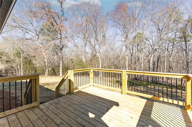 wooden deck with a wooded view