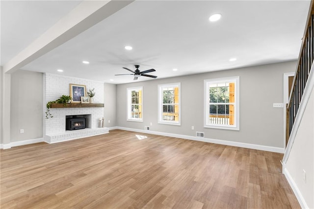 unfurnished living room featuring baseboards, light wood-style flooring, visible vents, and recessed lighting