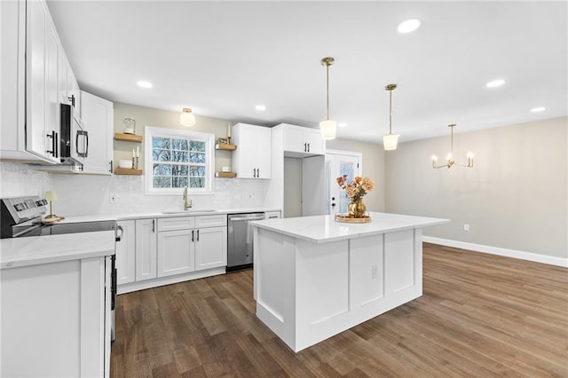 kitchen with dark wood-style floors, open shelves, appliances with stainless steel finishes, and a sink