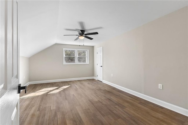 additional living space with lofted ceiling, ceiling fan, baseboards, and wood finished floors