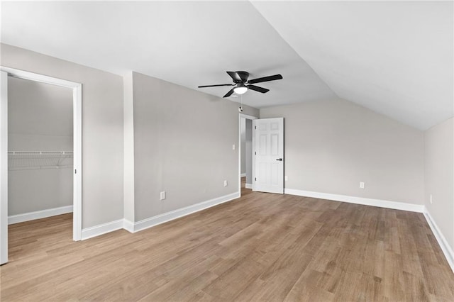 additional living space with lofted ceiling, light wood finished floors, a ceiling fan, and baseboards