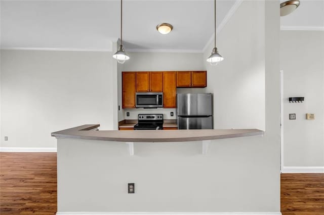 502 SW Pryor St SW Unit 325, Atlanta, GA 30312 - kitchen with stainless steel appliances, dark wood-type flooring, ornamental molding, brown cabinets, and decorative light fixtures