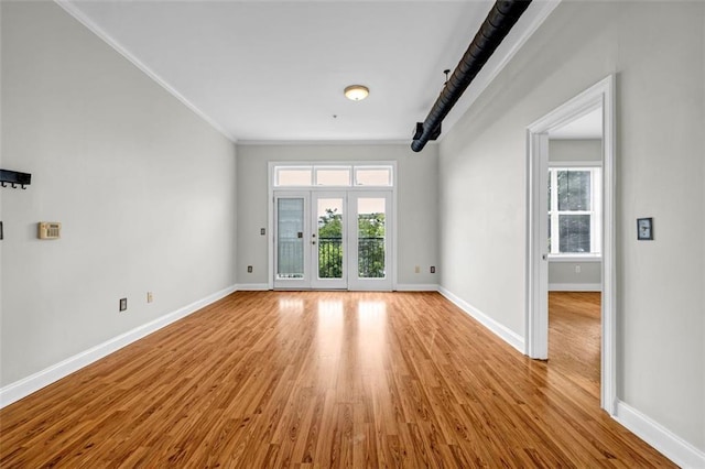 502 SW Pryor St SW Unit 325, Atlanta, GA 30312 - empty room featuring light wood-style flooring, healthy amount of natural light, baseboards, and crown molding
