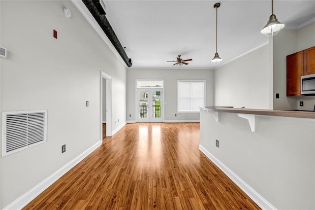 502 SW Pryor St SW Unit 325, Atlanta, GA 30312 - unfurnished living room with wood finished floors, a ceiling fan, baseboards, and crown molding