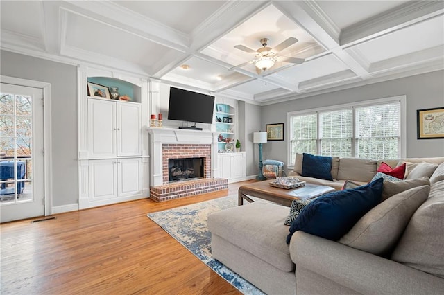 living room with ceiling fan, light hardwood / wood-style flooring, and a healthy amount of sunlight