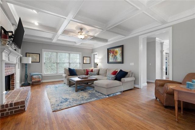 living room with hardwood / wood-style flooring, ceiling fan, a fireplace, and coffered ceiling