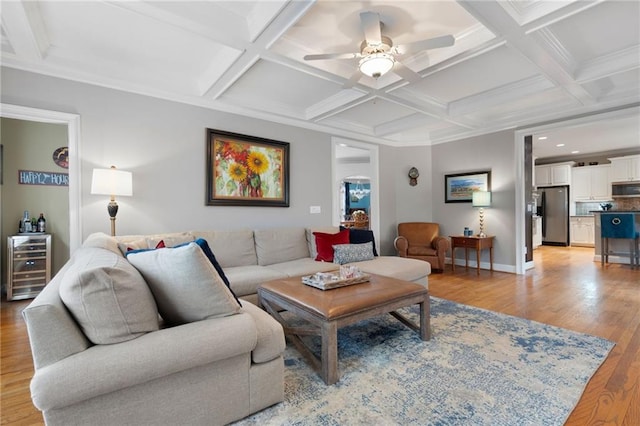 living room featuring beam ceiling, ceiling fan, coffered ceiling, wine cooler, and light wood-type flooring