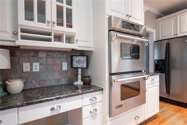 kitchen featuring white cabinets, light hardwood / wood-style floors, and stainless steel appliances