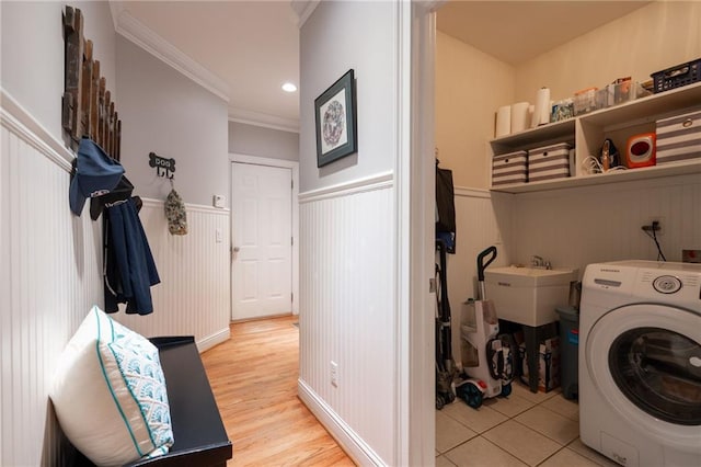 washroom featuring sink, washer / dryer, light wood-type flooring, and crown molding