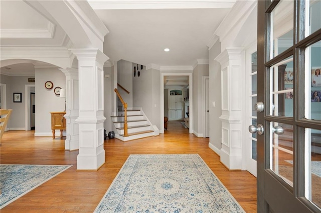 foyer entrance featuring light wood-type flooring and crown molding